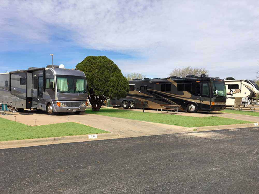 A row of paved RV sites at CAMELOT VILLAGE RV PARK