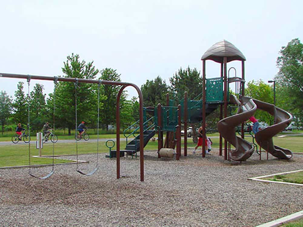 Playground with swing set at SAUDER VILLAGE CAMPGROUND