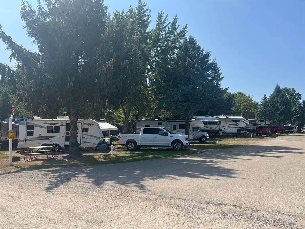 RVs and a truck in sites at Shipshewana Campground North Park & Amish Log Cabin Lodging