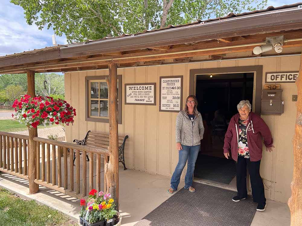Two people standing next to the office door at BAUER'S CANYON RANCH RV PARK