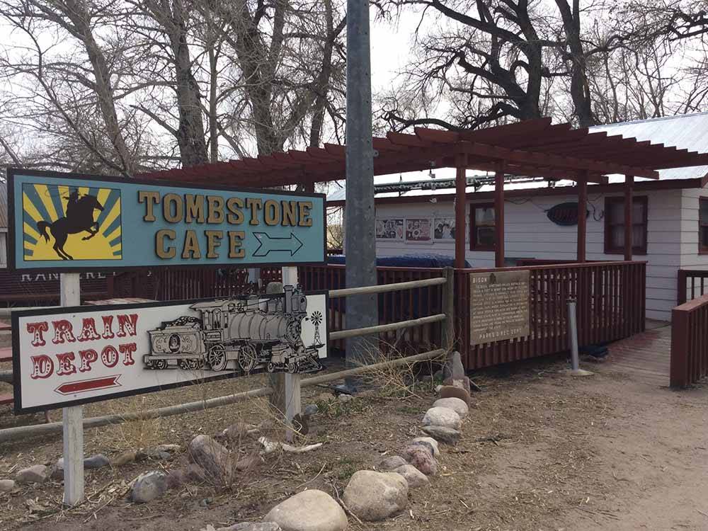 Signs leading to the cafe and train depot at TERRY BISON RANCH RV PARK