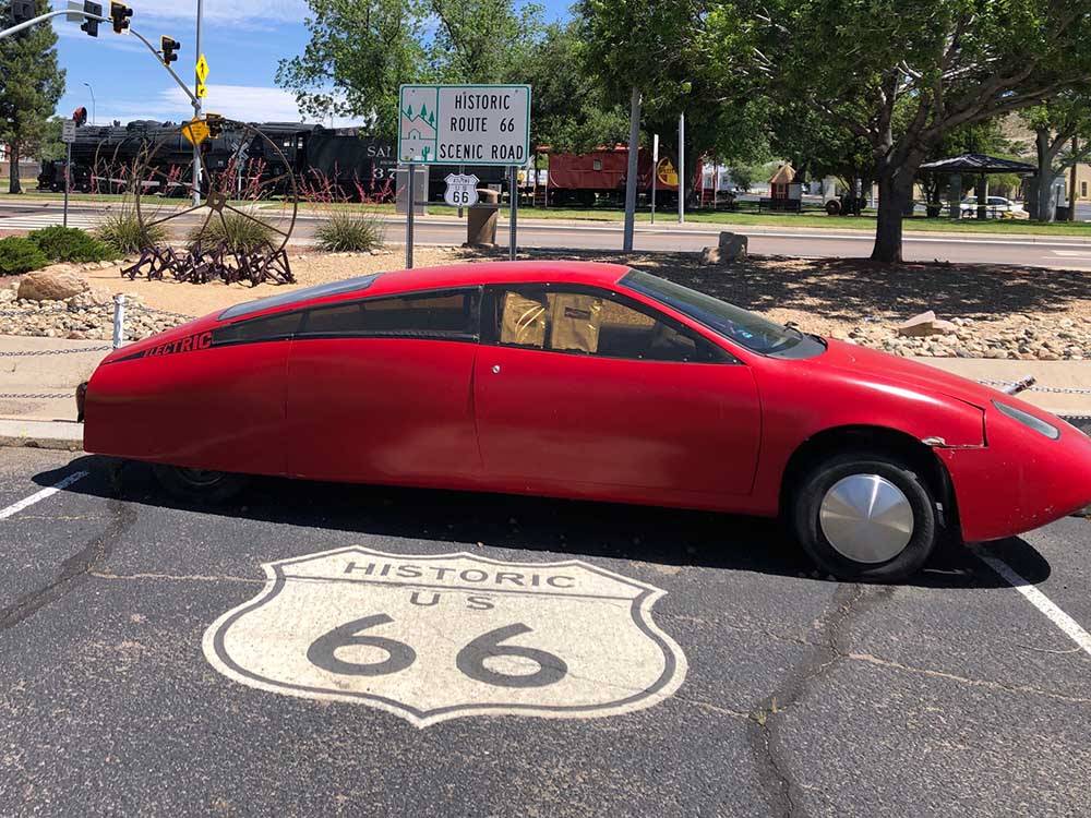 Electric car on Route 66 sign at ZUNI VILLAGE RV PARK