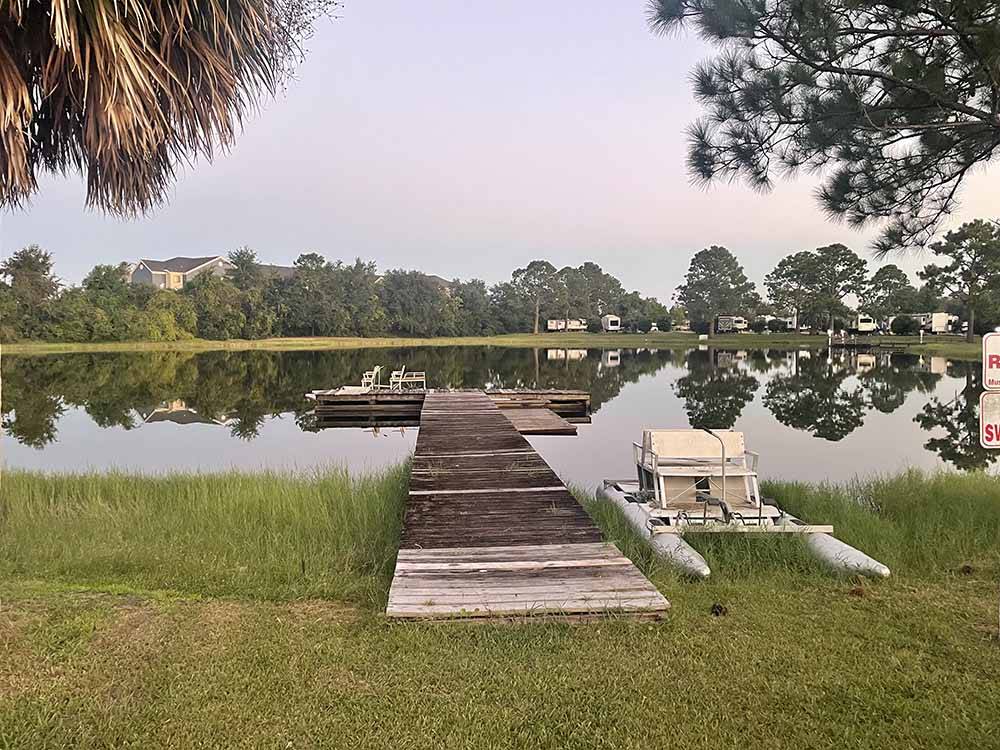 The wooden dock with chairs at GULF BREEZE RV RESORT