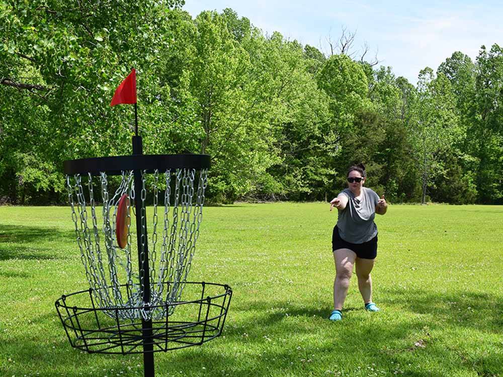 A person playing Frisbee golf at QUILLY'S MAGNOLIA RV PARK