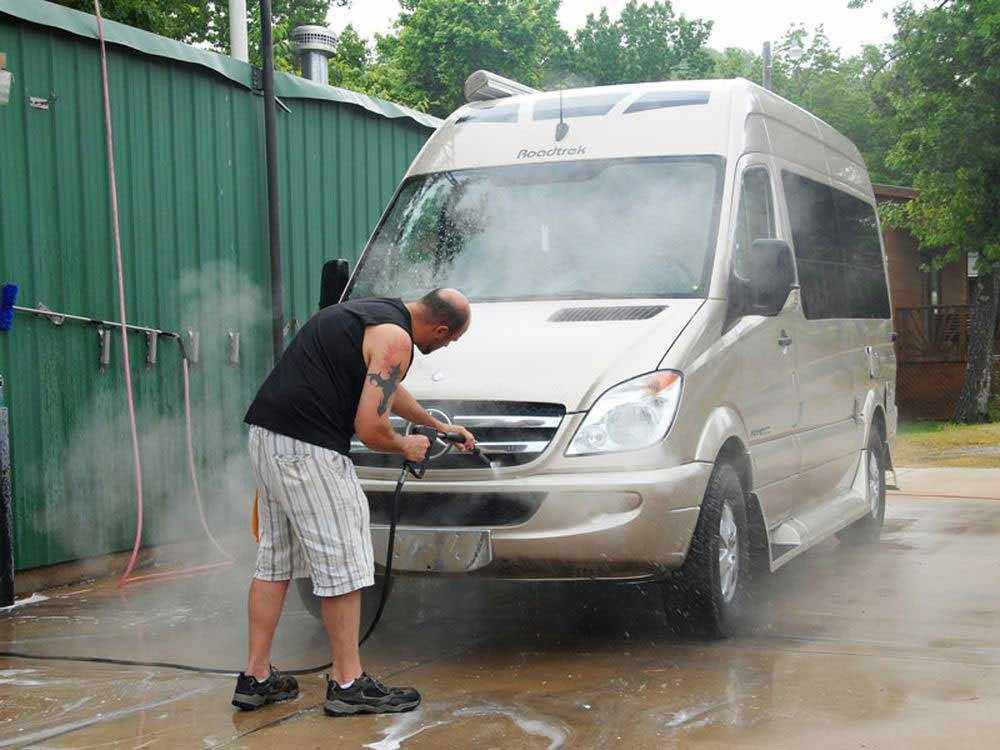 A man washing his RV at AMERICA'S BEST CAMPGROUND
