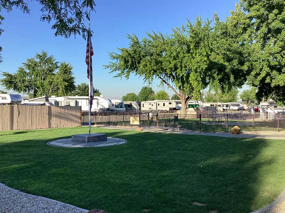 Grassy area with American flag at HI VALLEY RV PARK