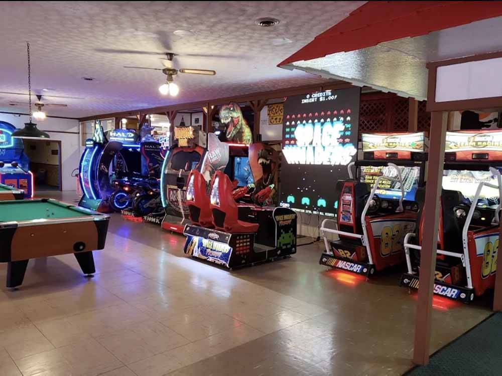 Arcade games and a pool table in the rec room at LAKE RIDGE RV RESORT