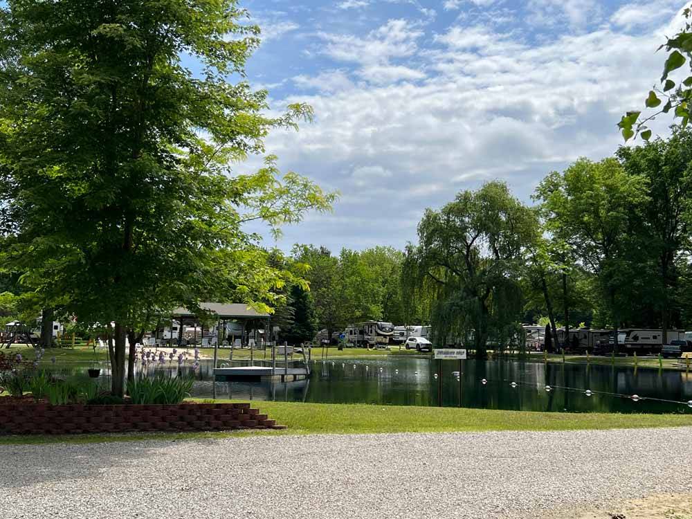 The swimming lake with a dock at BLUEGRASS CAMPGROUND