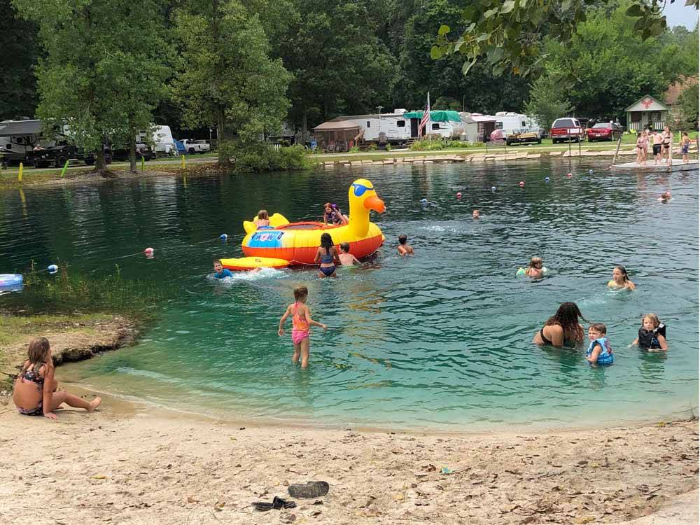 Families swimming in the lake at BLUEGRASS CAMPGROUND