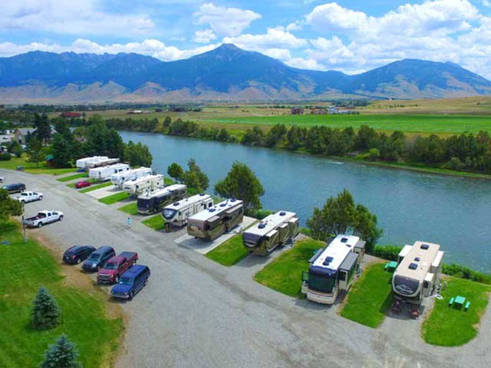 RVs parked in waterfront sites at YELLOWSTONE'S EDGE RV PARK
