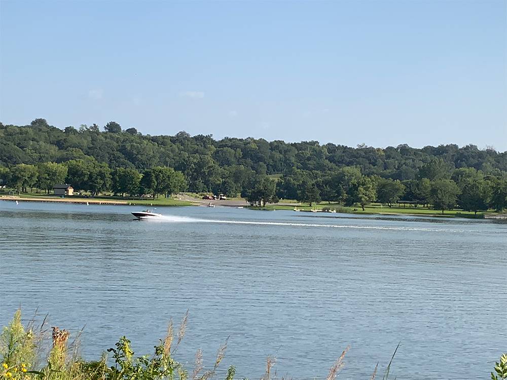 A speed boat on the lake at Lake Byllesby Campground