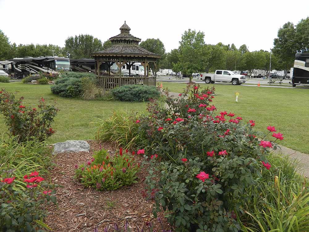 Flowers in front of a gazebo at COTTONWOODS RV PARK