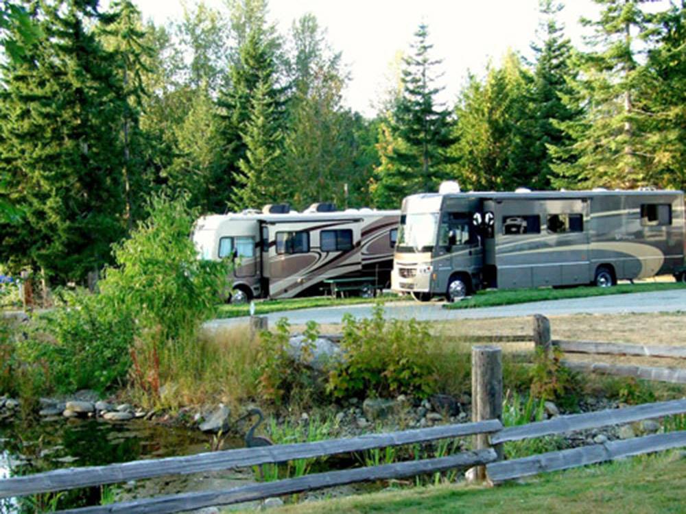 RVs parked in row with wooden fence at ELWHA DAM RV PARK