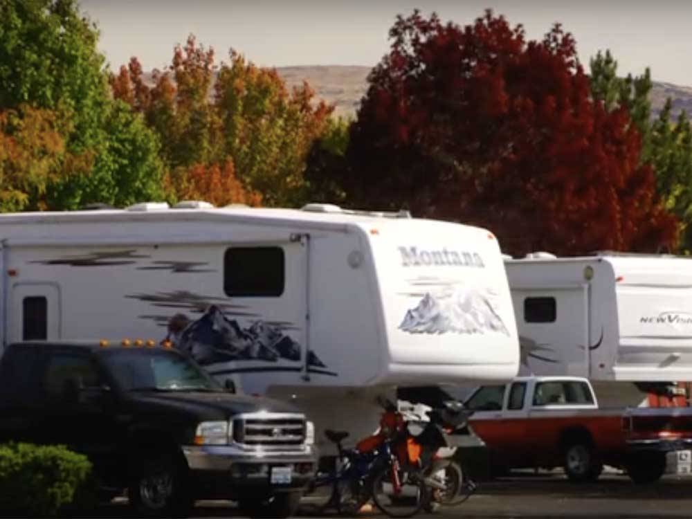 A line of RVs in campsites at VICTORIAN RV PARK