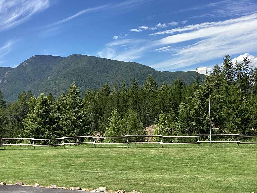 A large grassy meadow at MOUNTAIN MEADOW RV PARK & CABINS