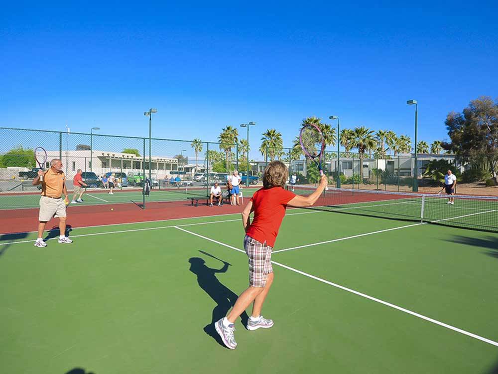 Couples playing tennis at SUN LIFE RV RESORT