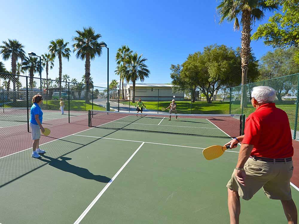 Couples playing pickleball during the day at SUN LIFE RV RESORT