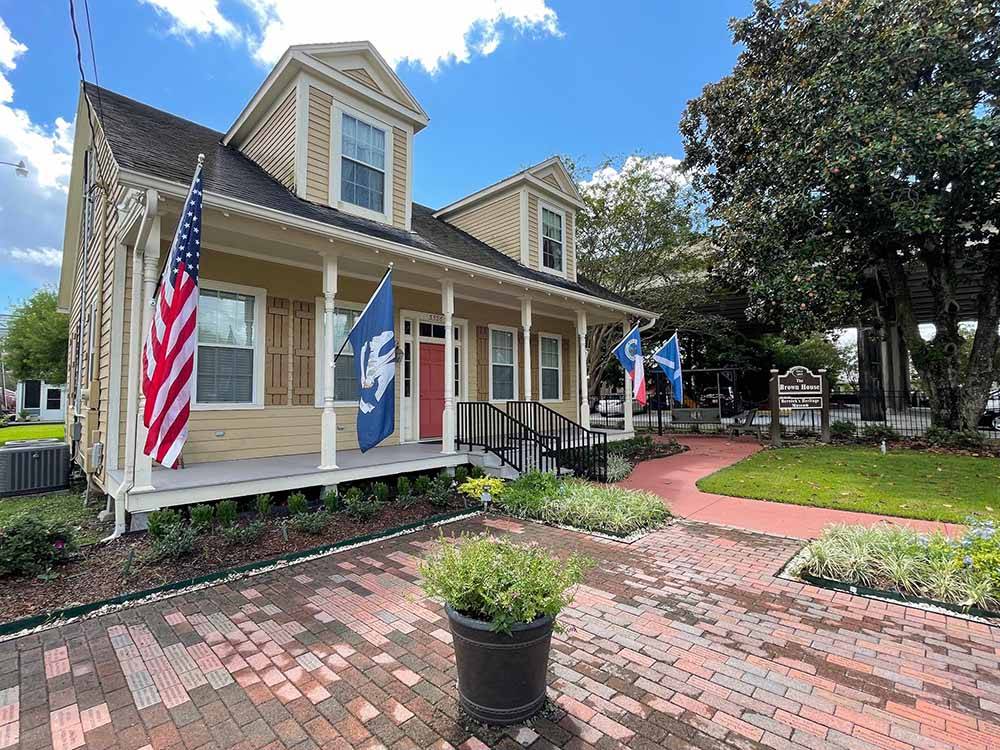 The Brown House historical home with flags at CAJUN COAST VISITORS & CONVENTION BUREAU