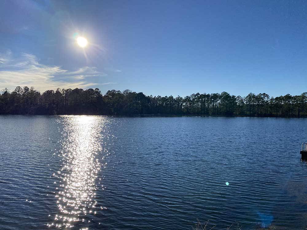 The sun beaming on the lake at LAKE HARMONY RV PARK AND CAMPGROUND
