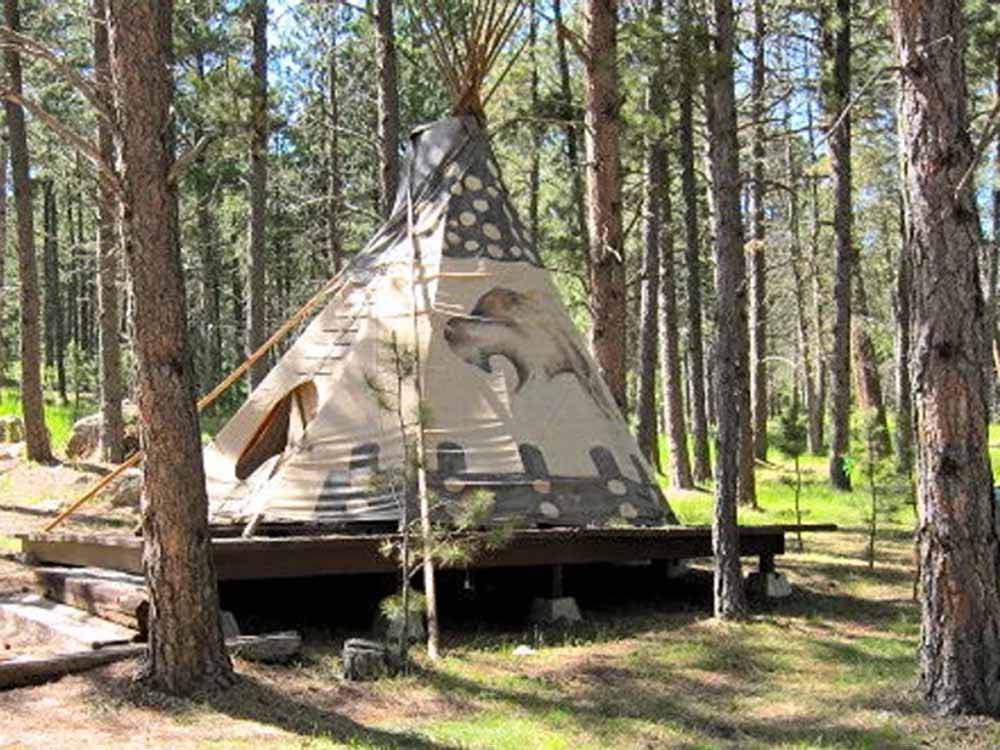 A teepee on a raised platform at FORT WELIKIT FAMILY CAMPGROUND
