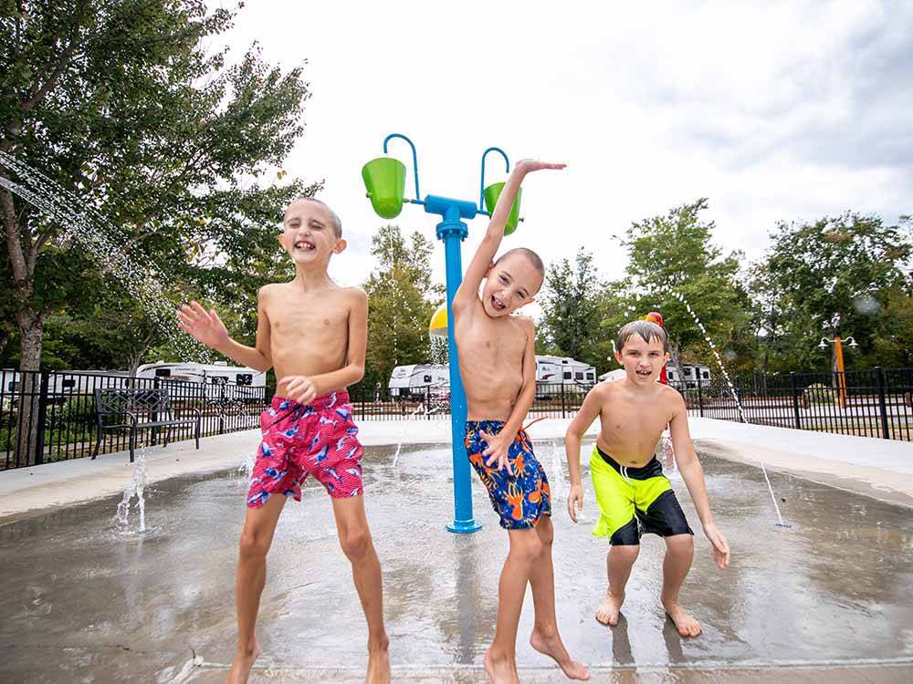 A group of boys playing in the water park at BIG MEADOW FAMILY CAMPGROUND
