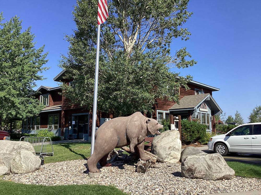 A bear figurine with rocks at YELLOWSTONE GRIZZLY RV PARK