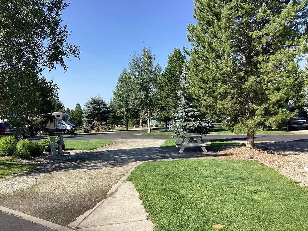 A gravel site with a bench at YELLOWSTONE GRIZZLY RV PARK