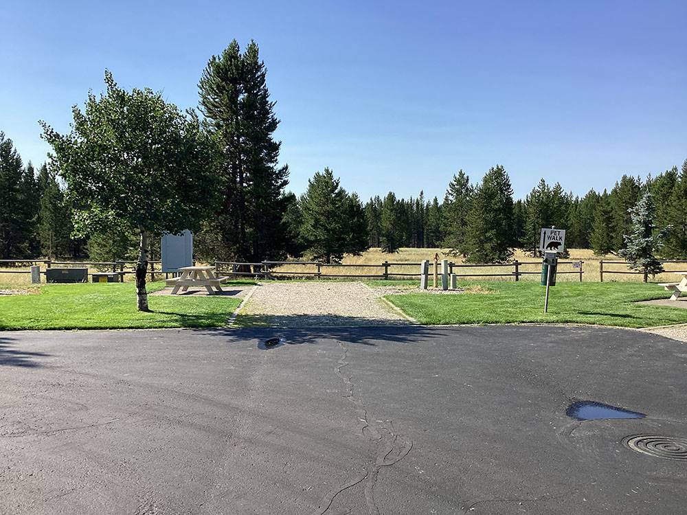 The road next to an empty site at YELLOWSTONE GRIZZLY RV PARK