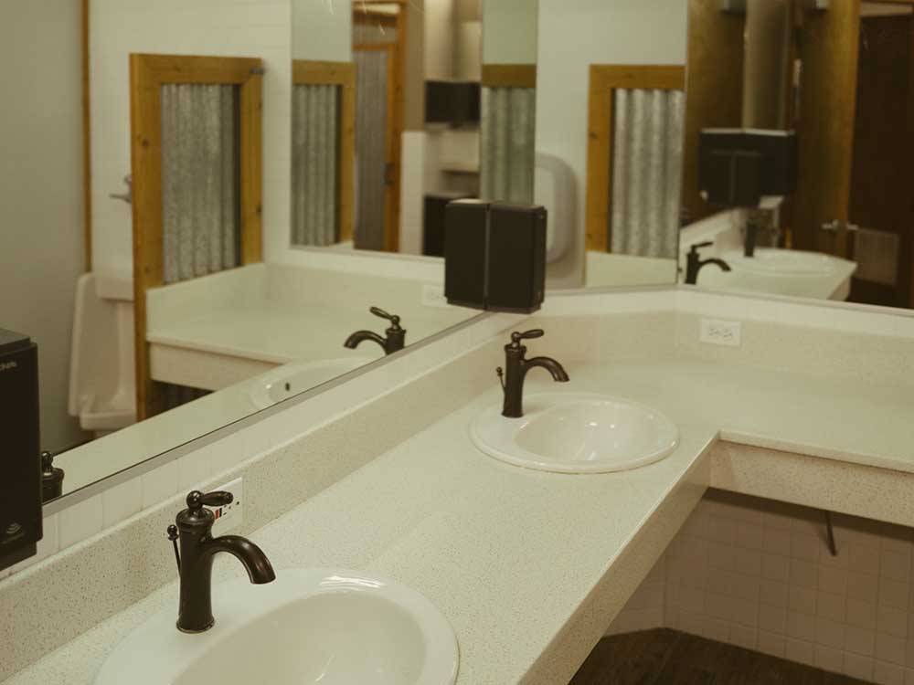 Multiple sinks inside the bathroom at ALDERWOOD RV PARK