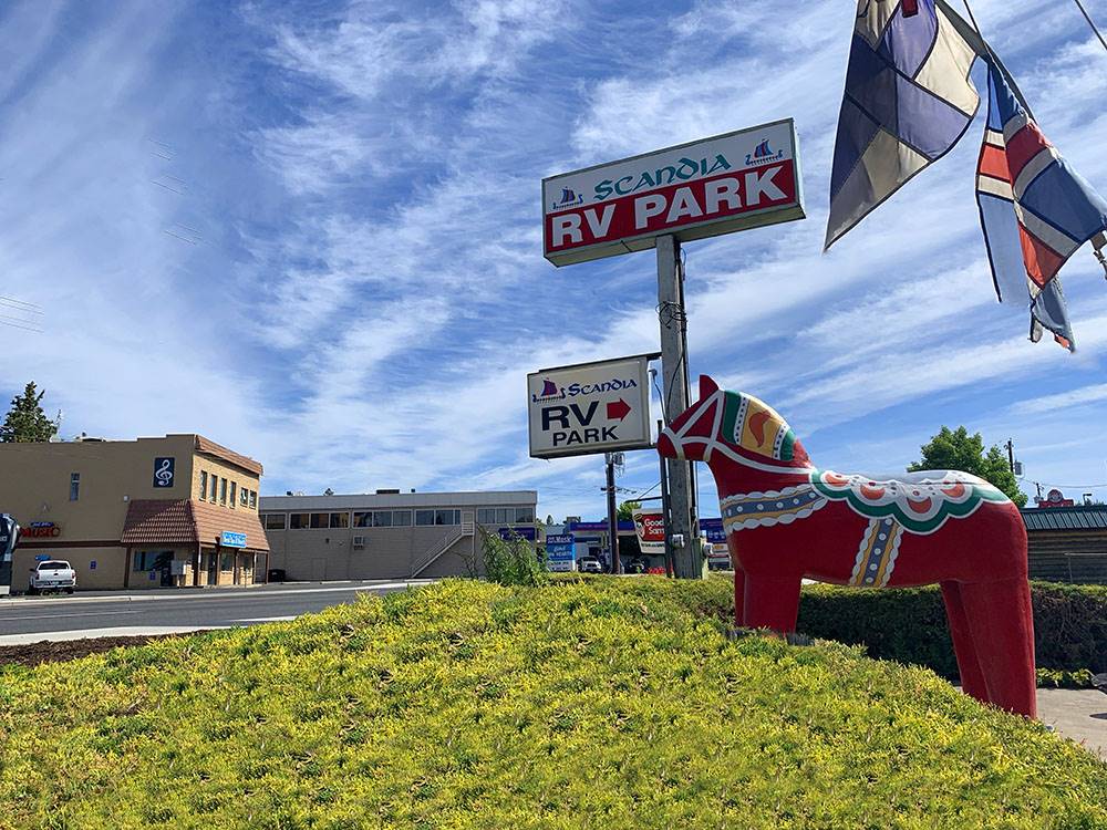 Park entrance with horse statue in front under sign at SCANDIA RV PARK