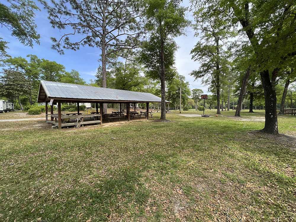 A covered pavilion with trees at RIVERS EDGE RV CAMPGROUND