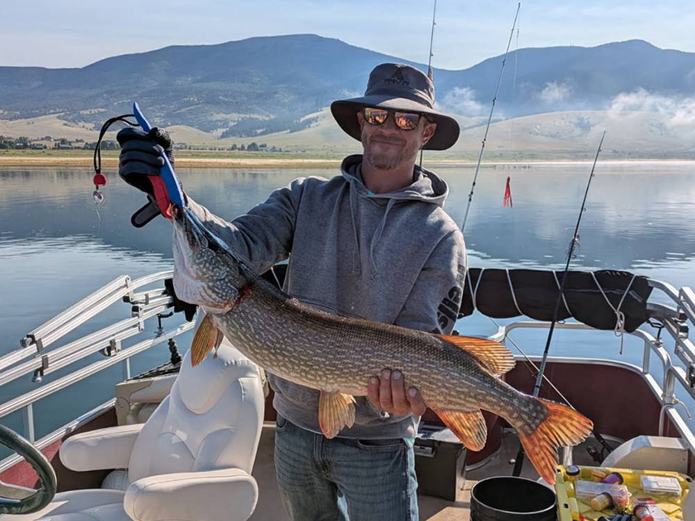 A man holding a fish he caught