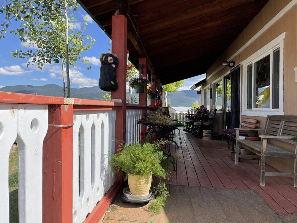 A covered porch with seating