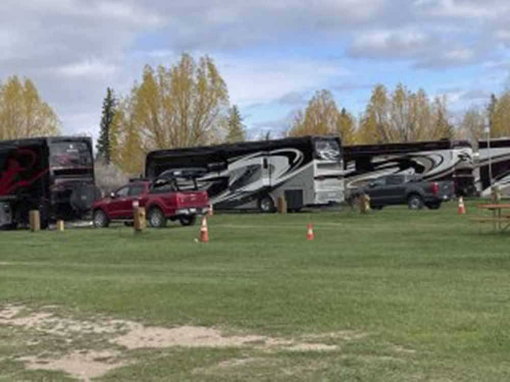 A row of motorhomes in RV sites at FORT BRIDGER RV PARK