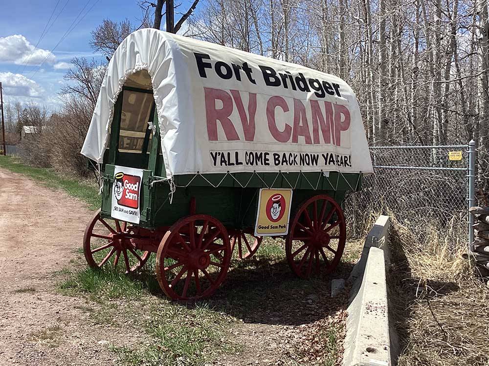 A covered wagon with campground name at FORT BRIDGER RV PARK