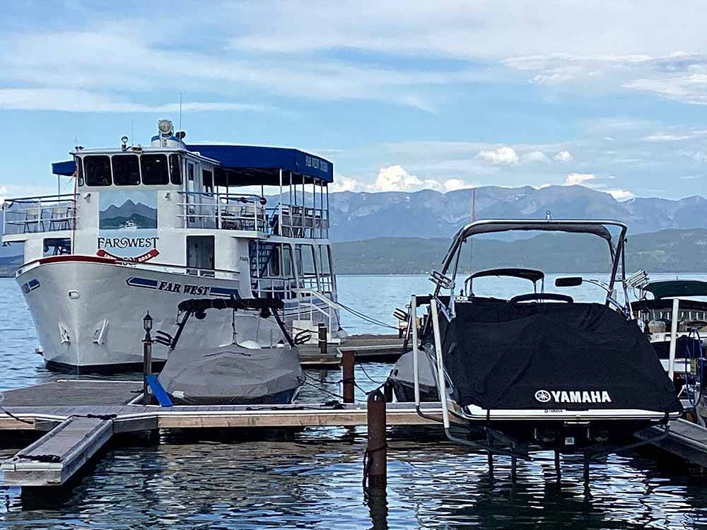 A group of boats on the dock at FLATHEAD HARBOR RV, LUXURY CONDOS AND CABINS (FORMERLY EDGEWATER RESORT)