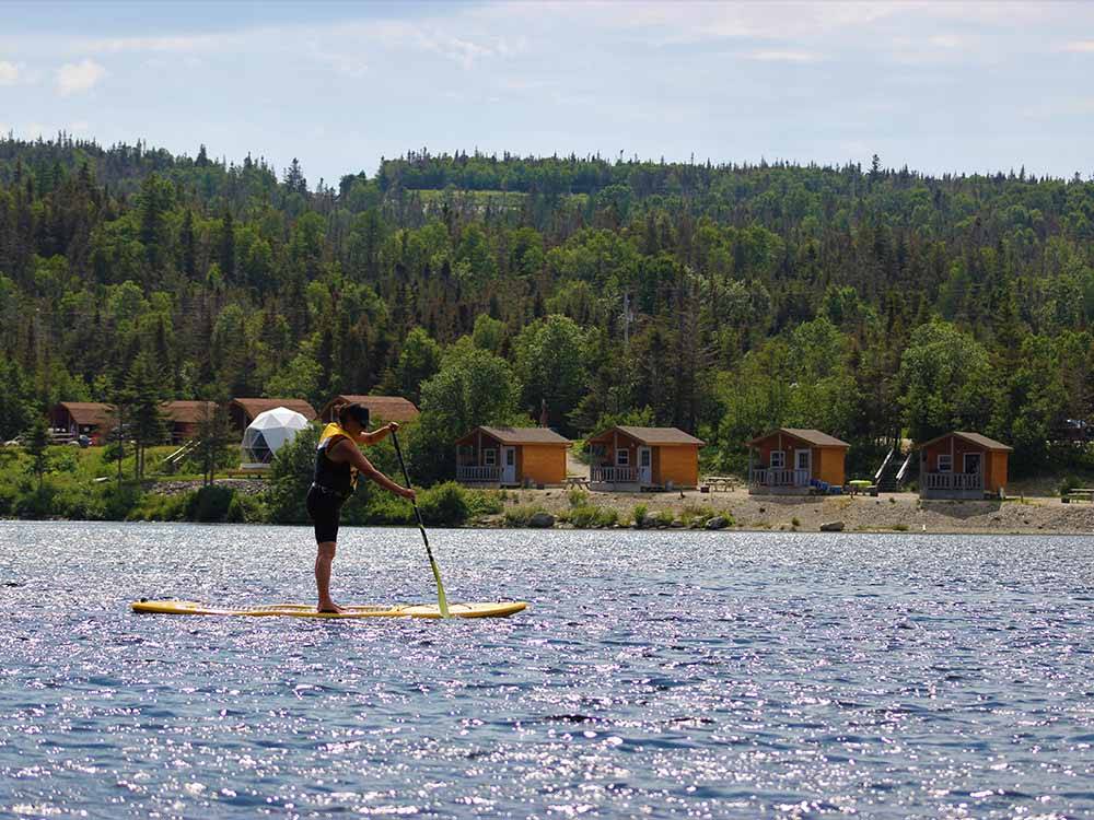 A person on a stand up paddle board at GROS MORNE/NORRIS POINT KOA