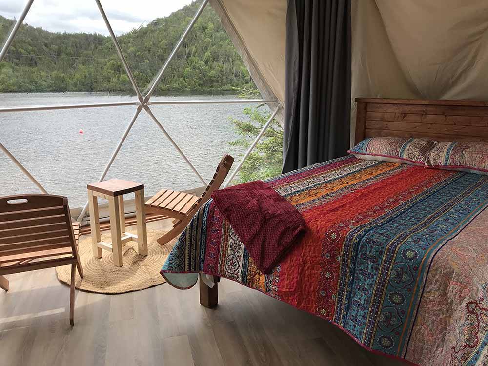 Inside of a glamping geodesic dome overlooking the water at GROS MORNE/NORRIS POINT KOA