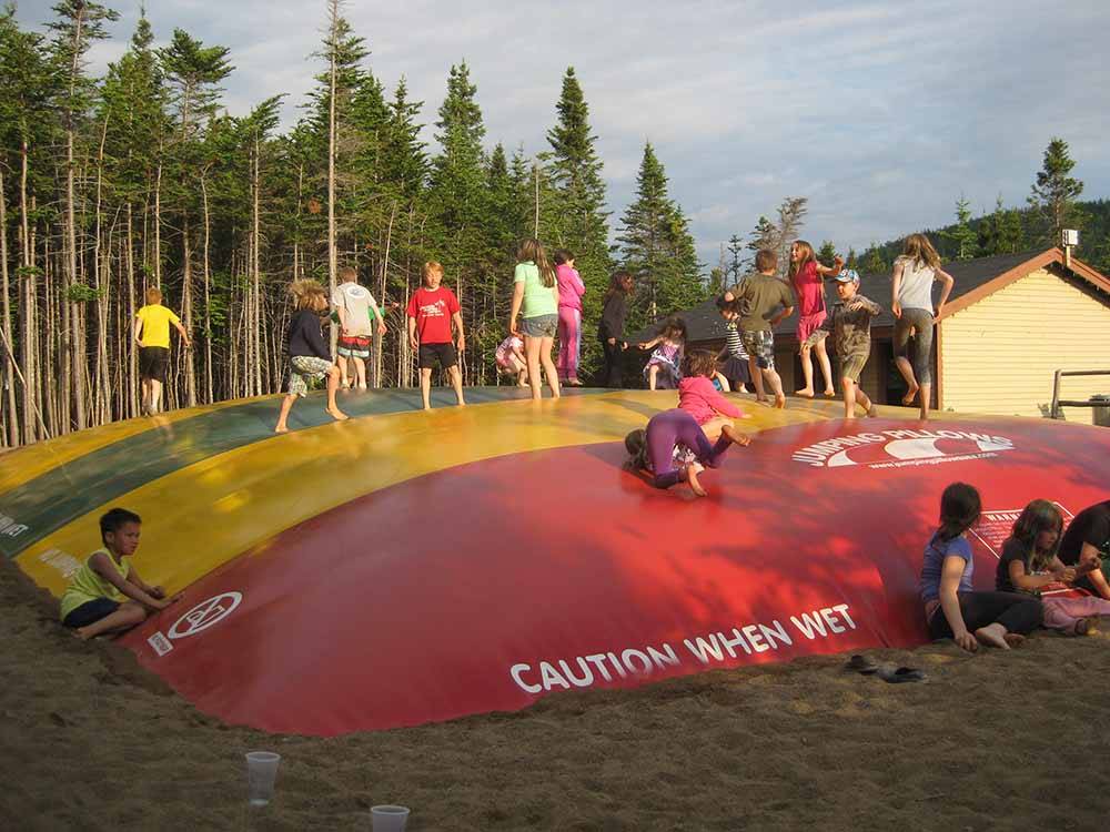 A group of kids on the jumping pillow at GROS MORNE/NORRIS POINT KOA
