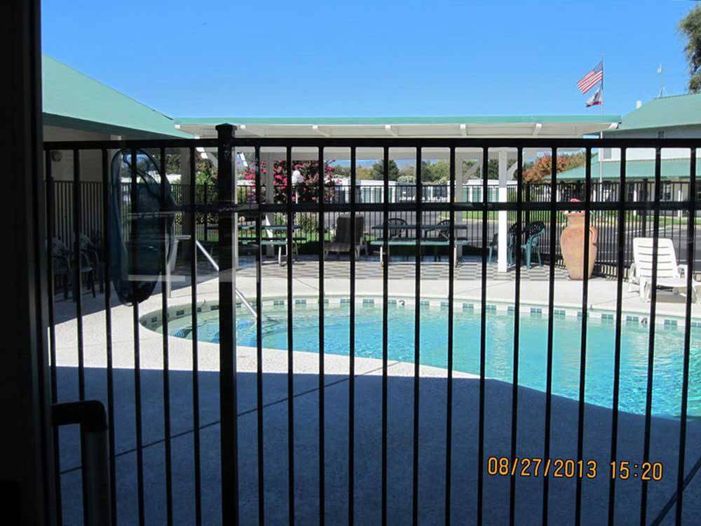 The fenced in pool area at ALMOND TREE RV PARK