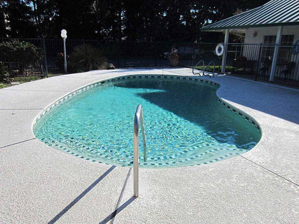 The kidney shaped pool at ALMOND TREE RV PARK