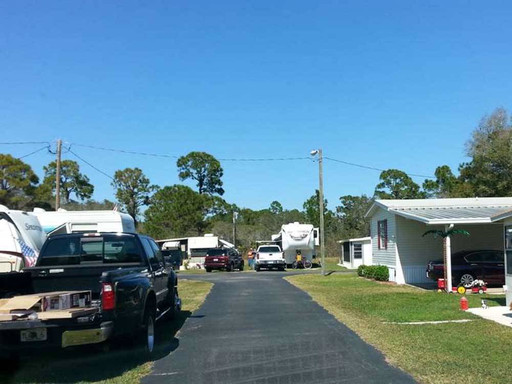 The paved road between manufactured homes and RVs at SEBRING GARDENS RV COMMUNITY