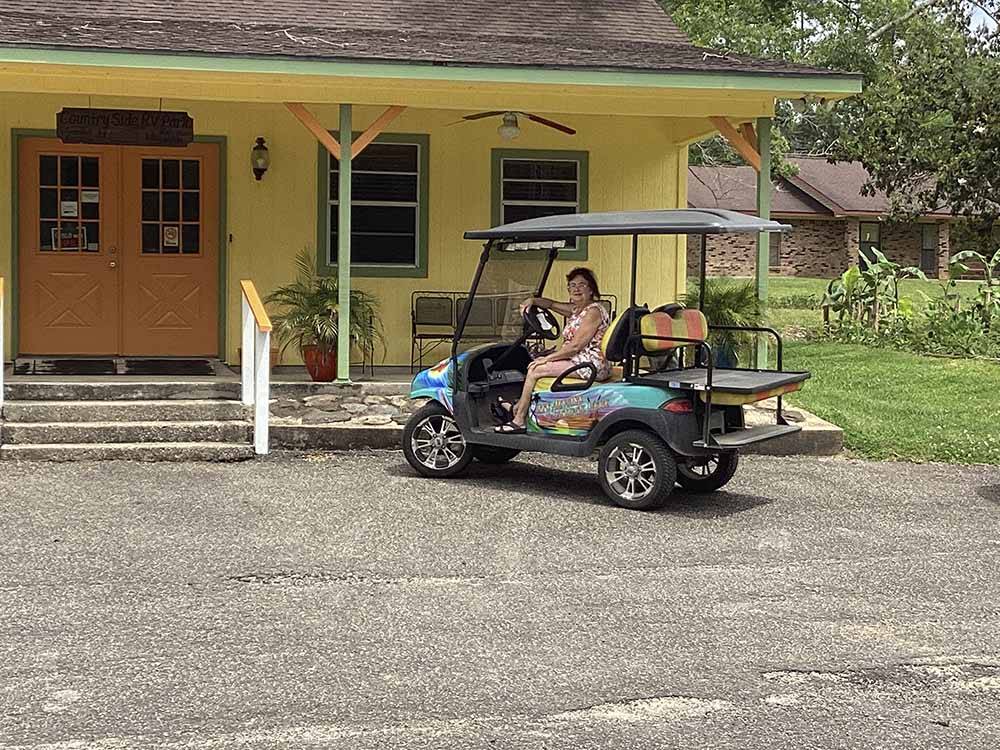 A golf cart in front of the office at COUNTRY SIDE RV PARK