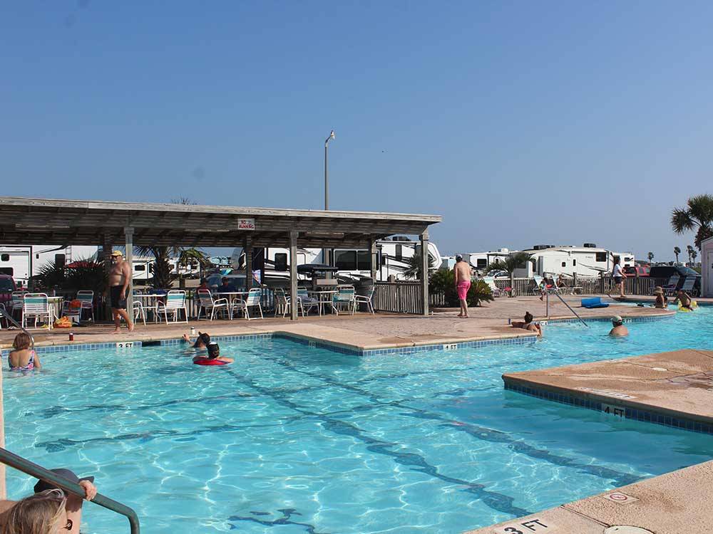 Campers enjoying the swimming pool at PIONEER BEACH RESORT