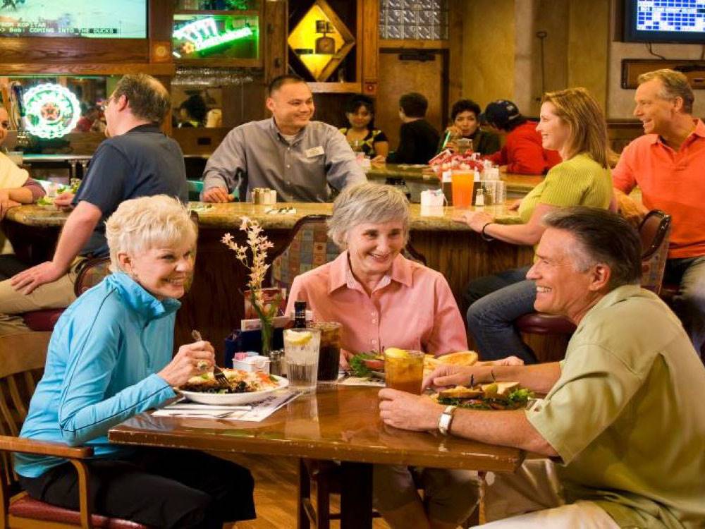 People dining at tables at Arizona Charlie's Boulder RV Park