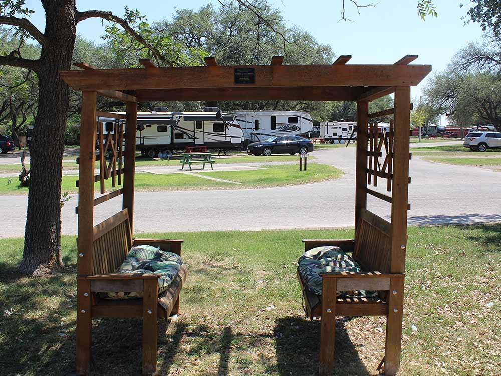 A seating area under a tree at QUAIL SPRINGS RV PARK