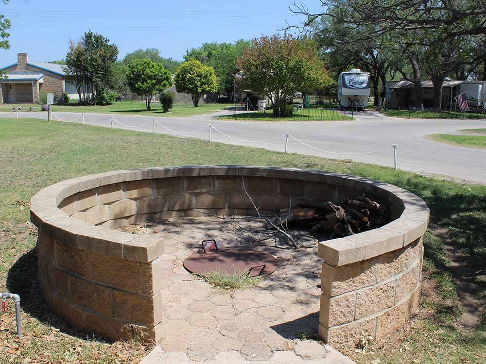 The closed fire pit with a brick wall at QUAIL SPRINGS RV PARK