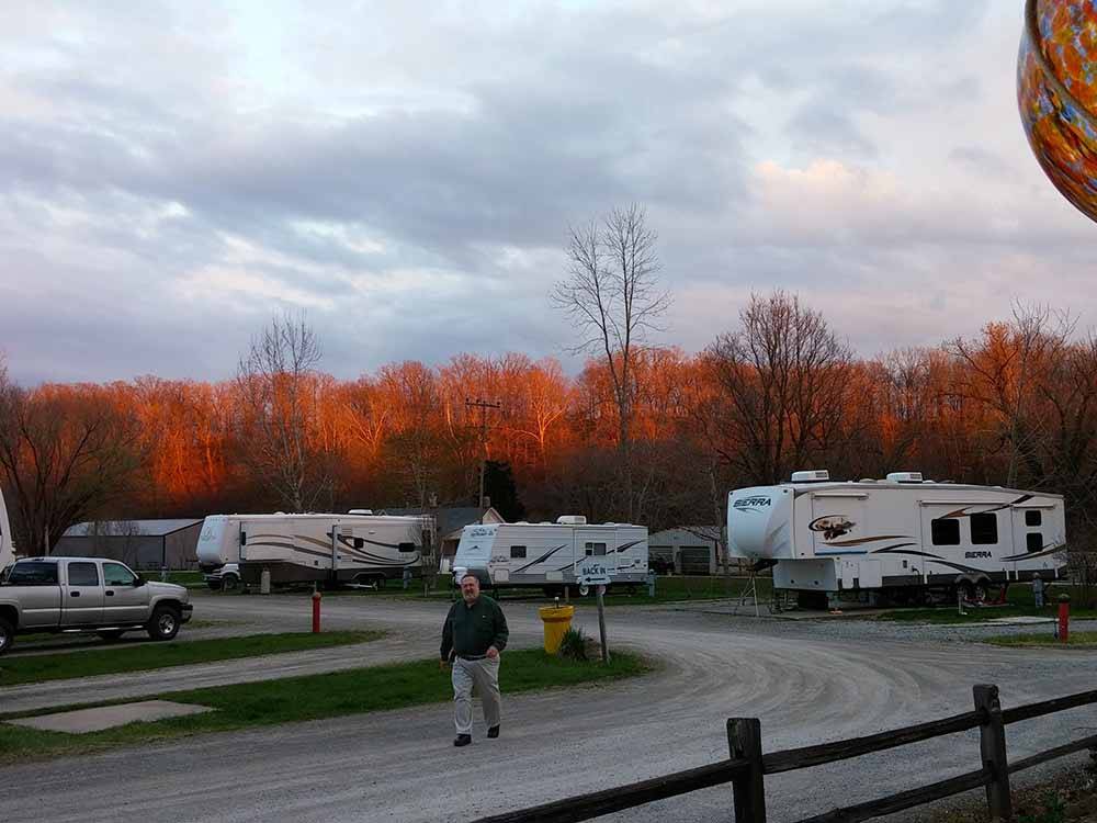 A man walking down a gravel road at COZY C RV CAMPGROUND