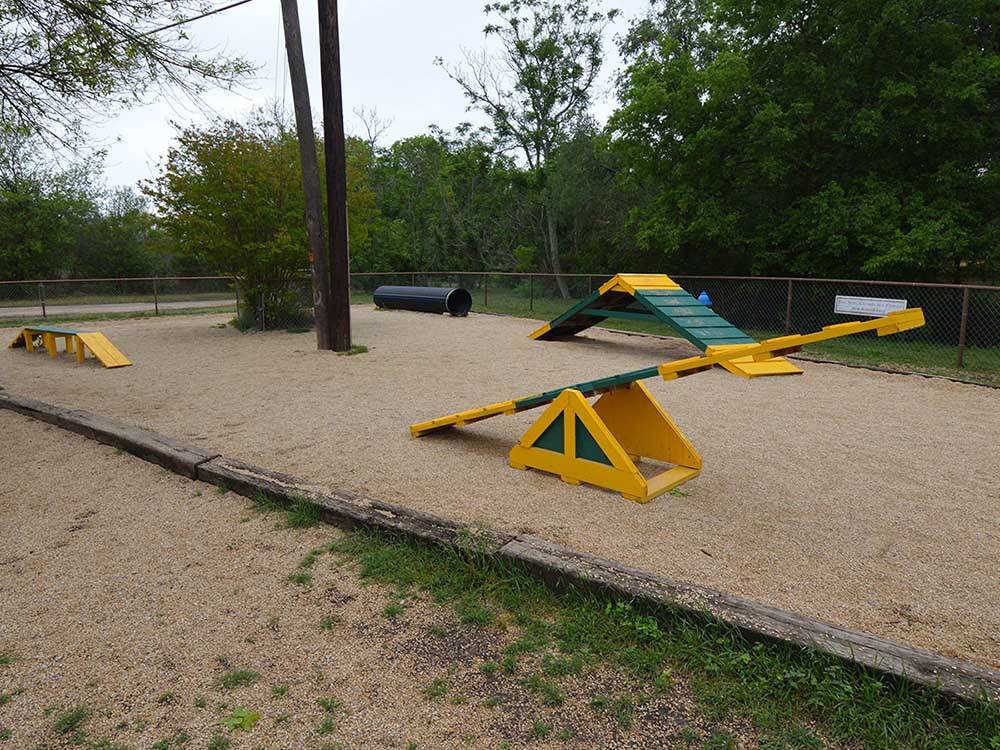 Playground equipment in the sand at STONE CREEK RV PARK