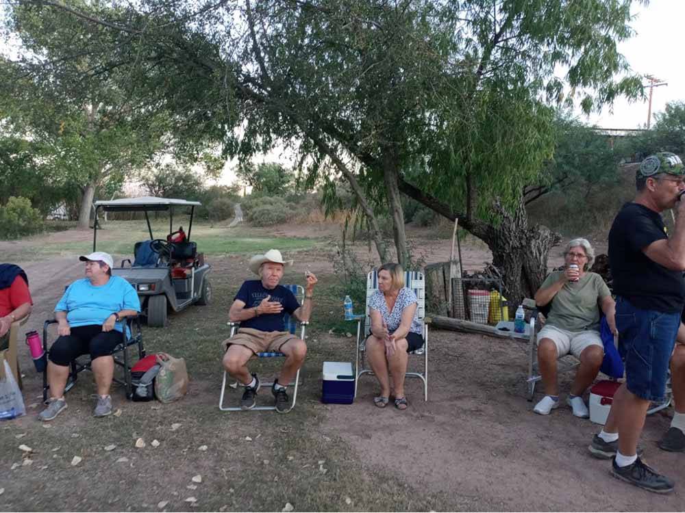 People sitting on lawn chairs at PATO BLANCO LAKES RV RESORT